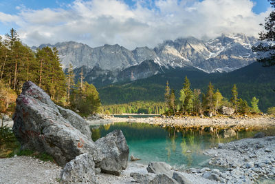 Scenic view of lake and mountains against sky