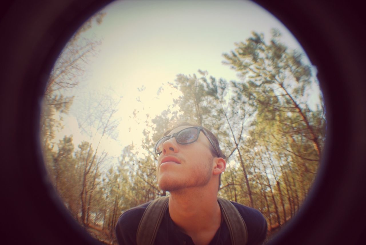 headshot, lifestyles, young adult, leisure activity, person, looking at camera, portrait, tree, sunglasses, front view, human face, head and shoulders, young men, close-up, sky, smiling, mid adult