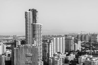 Modern buildings in city against clear sky