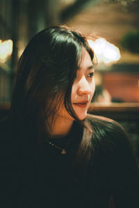 Close-up of young woman looking away