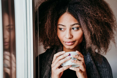 Portrait of a beautiful young woman drinking coffee