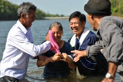 Group of people against calm water