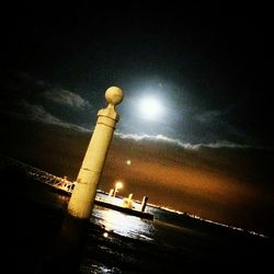 Low angle view of illuminated street light at night