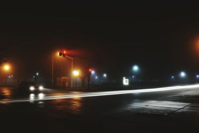 Illuminated city street at night