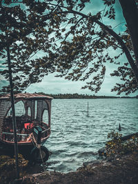 Bicycle by lake against sky