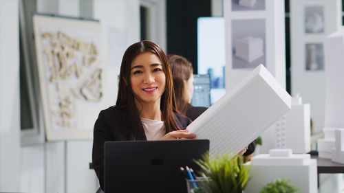 Young woman using laptop at office