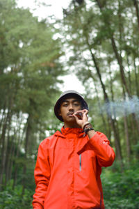 Full length of a young man standing in forest