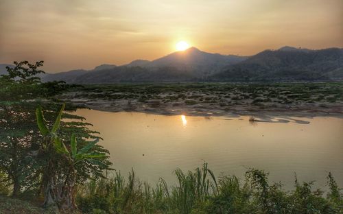 Scenic view of lake at sunset