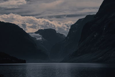 Scenic view of sea and mountains against sky