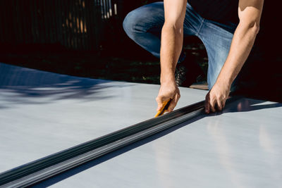 Low section of man skateboarding on city