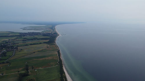 Aerial view of land and sea against sky