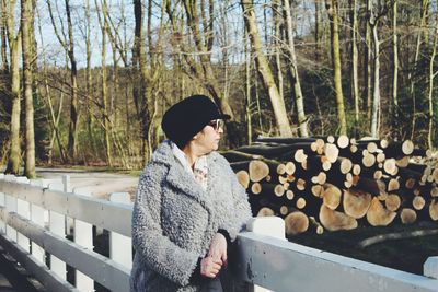 Thoughtful woman standing by railing