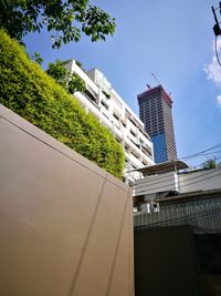 Low angle view of buildings against clear blue sky