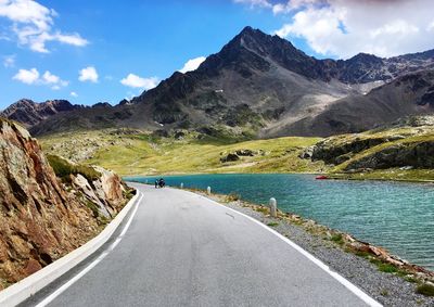 Road by river against mountain