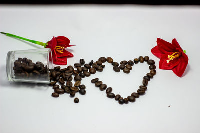 Close-up of red roses on white table