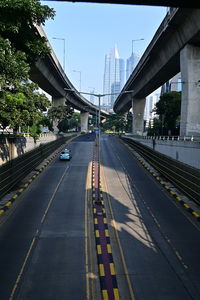 View of bridge over road along buildings