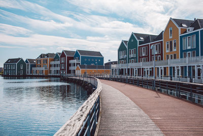 View of canal amidst buildings against sky