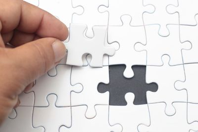 Cropped hand of person playing puzzle