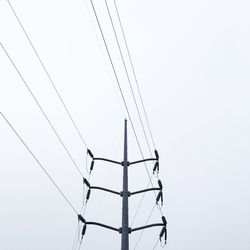 Low angle view of electricity pylon against sky