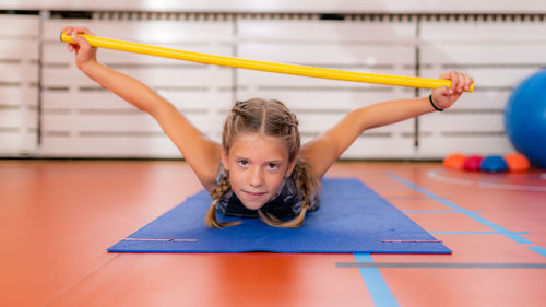 Back strengthening exercise for children with a bar