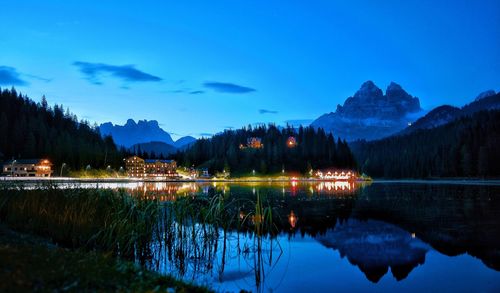 Scenic view of lake against sky at dusk