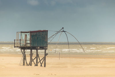 Old abandoned wooden fishery in loire atlantique in the country of retz on a beach