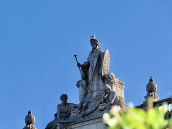 Low angle view of statue against clear blue sky