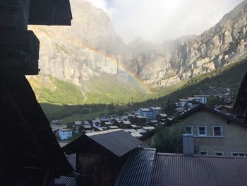 Houses on mountain against sky