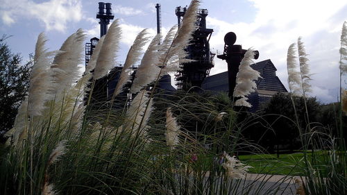 Low angle view of fountain against cloudy sky