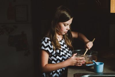 Girl making food in kitchen at home