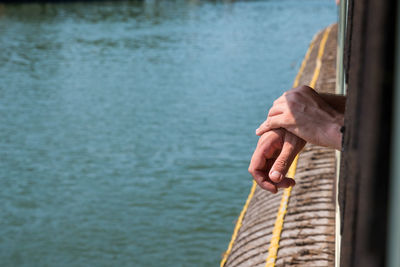 Cropped image of man by lake