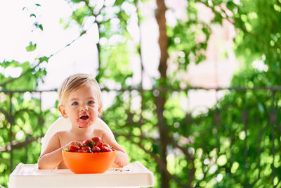 Portrait of cute girl sitting on table