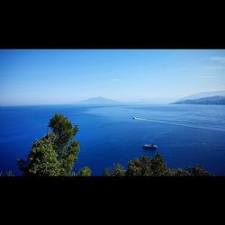 Scenic view of sea against blue sky