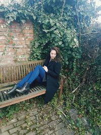 Portrait of young woman sitting outdoors