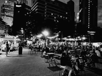 Panoramic view of people in city at night