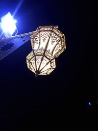 Low angle view of illuminated ferris wheel at night
