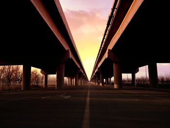 Bridge over road against sky in city