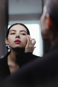 Portrait of a beautiful young woman red lips blue eyes