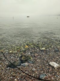 High angle view of rocks in sea against sky