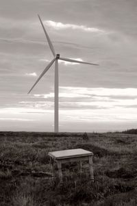 Windmill on field against sky