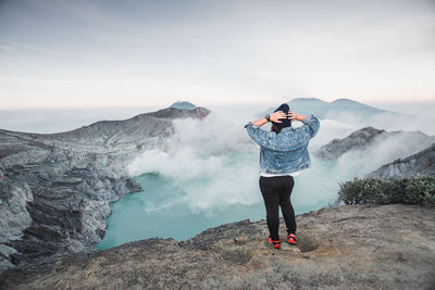 Man standing on mountain against sky