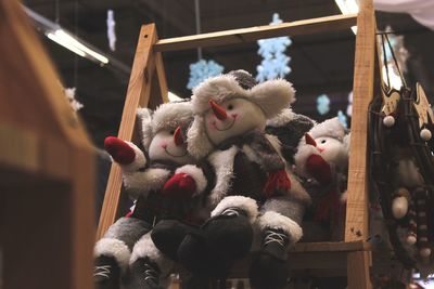 Stuffed toy hanging on wood in winter