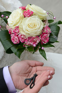 Cropped hands of bride and groom holding keys