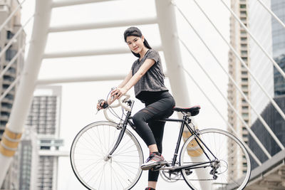 Young woman riding bicycle