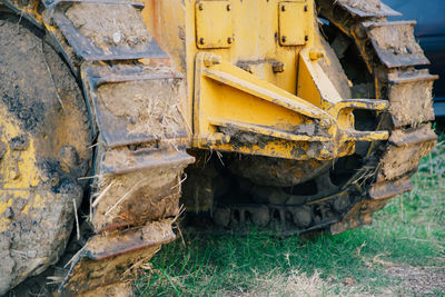 Close-up of construction machinery on field