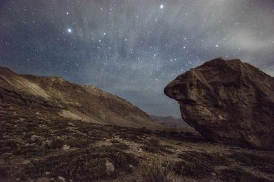 Scenic view of mountain against sky at night