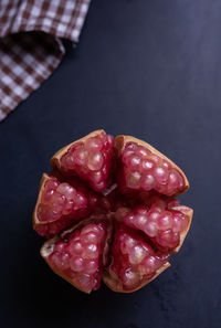High angle view of strawberries on table against black background