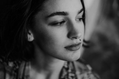 Close-up portrait of young woman looking away