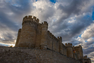 Low angle view of historic building against cloudy sky