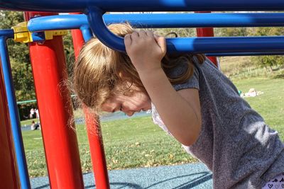Full length of boy playing on slide at playground